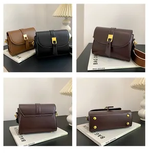Detail view of vintage flap crossbody bags featuring gold buckles and wide fabric straps