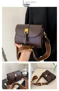 Detail view of coffee brown crossbody bag with gold buckle and wide woven shoulder strap