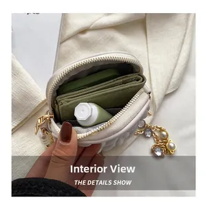 Detail view of the cream quilted bag interior with pearls, showing the inner storage space