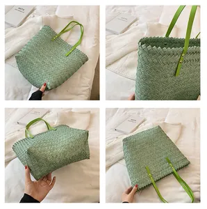 Detail view of green woven straw tote bag with cross-weave texture and metal rivets