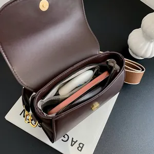 Deep brown matte PU leather crossbody bag with partitioned interior and wide canvas strap