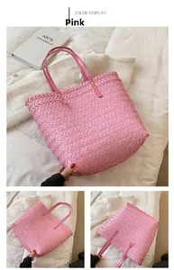 Detail view of pink woven tote bag showing cross-stitch texture and shoulder strap rivets