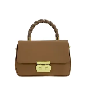 Brown faux leather crossbody bag featuring a twisted handle and gold metal lock