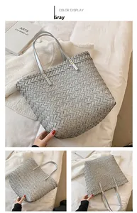 Detail view of grey woven tote bag featuring leather texture and gold rivet hardware
