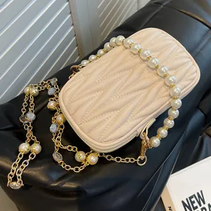 Elegant beige pleated crossbody bag with pearl handle and rhinestone chain strap