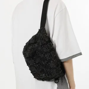 Distressed black canvas chest bag for women, crossbody style with adjustable strap