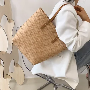 Minimalist straw woven tote bag with brown leather straps and large capacity for summer