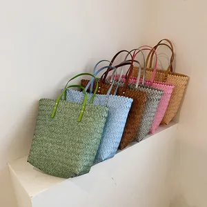 Minimalist summer straw bucket bags in six colors arranged on a white staircase