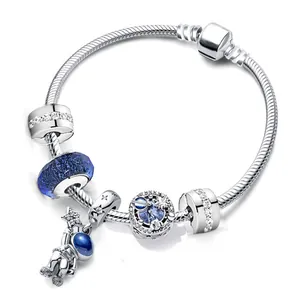 Astronaut themed snake chain bracelet with blue glass beads and star charms on white background