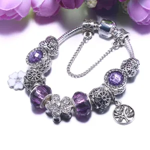 Silver snake chain bracelet with purple glass beads and tree of life flower charms