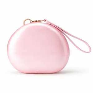 Detail of pink pearlescent acrylic evening clutch bag with rose gold clasp and strap
