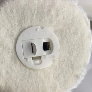Detail of white plush rabbit base showing battery compartment and power switch toggle