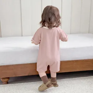 Pink short sleeve cotton baby bodysuit featuring contrast trim and comfy back view design