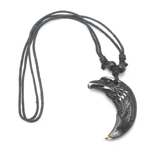 Détail du pendentif aigle tribal en résine avec texture imitation os et perles bois