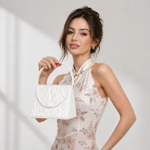 Elegant white acrylic evening bag with pearlescent wave texture and round buckle closure