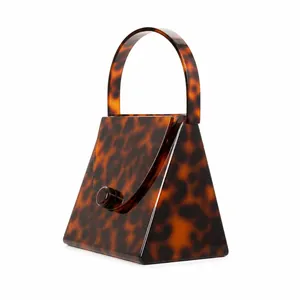 Close-up of tortoise shell pattern acrylic evening bag with structured handle