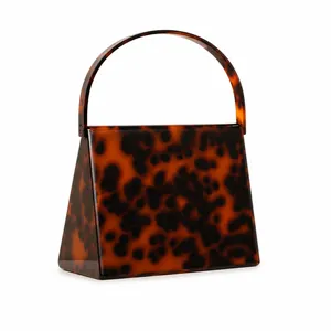 Close-up of tortoise shell pattern acrylic evening clutch with trapezoid structure