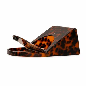 Detail of triangular tortoise shell acrylic evening clutch bag with round top handle