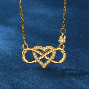 Elegant gold infinity heart pendant necklace with shimmering zircon stones on navy velvet