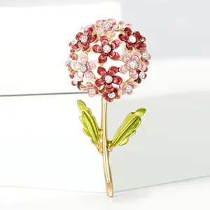 Close-up of pink hydrangea brooch with rhinestones and green enamel leaves