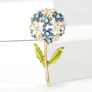 Macro detail of enamel hydrangea brooch with blue and white flowers and sparkling rhinestones