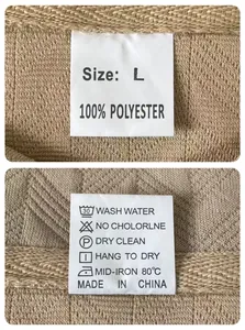 Detail view of the 100% polyester wash care and size label on a men's jacquard polo shirt
