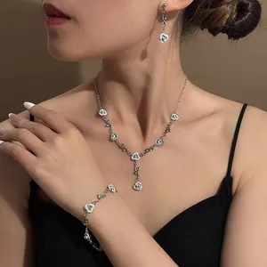 Model wearing white rose necklace, bracelet and earrings set in vintage French style