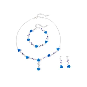 Detailed view of vintage romantic blue rose jewelry set with necklace, bracelet, and earrings