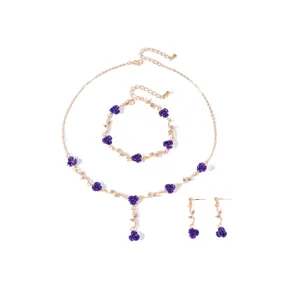 Detailed view of vintage French style purple rose jewelry set with necklace and earrings