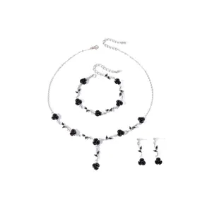 Detailed view of a retro black rose jewelry set with necklace, bracelet, and earrings.