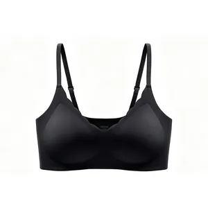 Detail view of seamless black V-neck bra with scalloped edges and adjustable straps