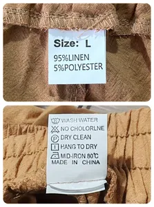 Detail view of clothing size L label and wash care instructions on linen blend pants
