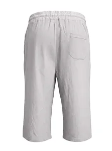 Detail of light grey linen trousers featuring elastic waistband and back pocket texture