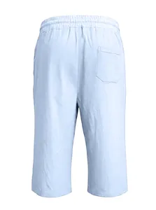 Detail view of light blue linen shorts featuring elastic waist and rear patch pocket