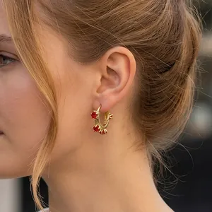 Golden flower hoop earrings with three red zircon stones in 18K plated copper finish