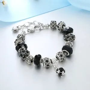 Detail of vintage silver beaded bracelet with black faceted beads and heart charm