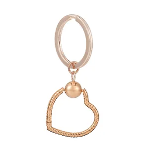 Rose gold heart pendant keychain with woven texture and circular open ring link