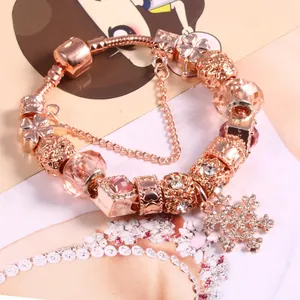 Rose gold snake chain charm bracelet with pink crystal beads and snowflake pendant