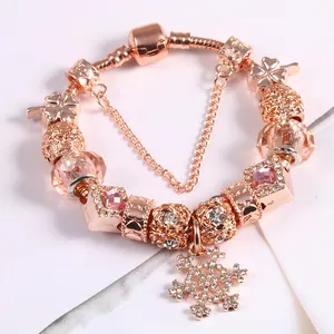 Rose gold snake chain charm bracelet with snowflake pendant and pink crystal beads