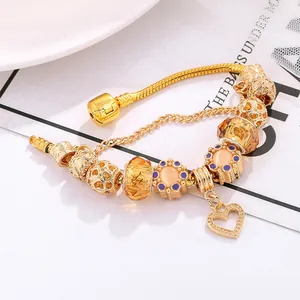 Golden charm bracelet with yellow crystal beads and hollow heart pendant on snake chain