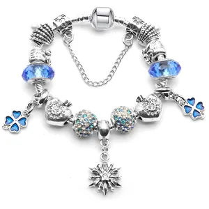 Silver charm bracelet with blue glass beads, gradient rhinestones and snowflake pendant