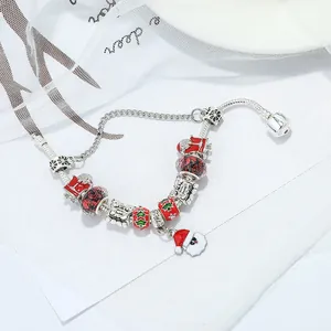 Christmas themed charm bracelet featuring Santa Claus, tree beads and snake chain