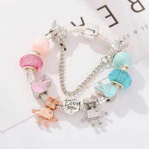 Macro detail of silver snake chain bracelet with robotic charms and glitter glass beads