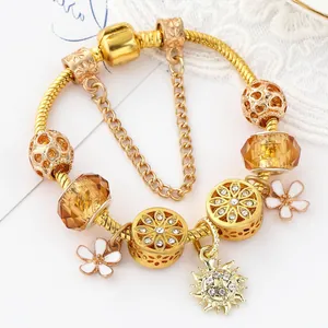 Golden snake chain charm bracelet with cherry blossom pendants and amber crystal beads