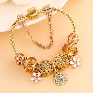 Golden snake chain bracelet with floral charms, amber glass beads and sunflower pendant
