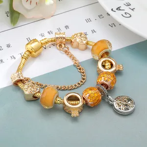 Golden bee charm bracelet with honey beads, heart pendant and tree of life charm