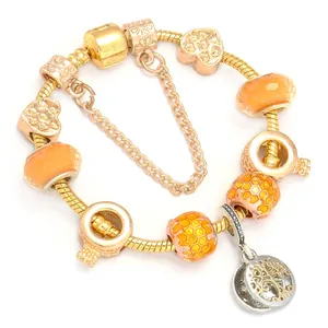 Golden bee charm bracelet with orange glass beads and tree of life pendant on snake chain