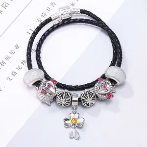 DIY luxury flower pendant with pink crystals on a black braided leather wrap bracelet
