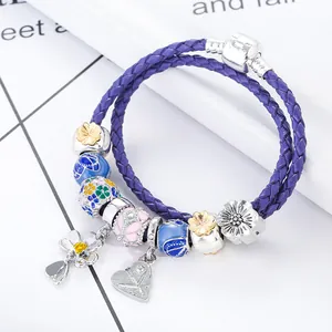 Purple leather wrap bracelet with floral enamel beads and daisy charms in 45-degree angle