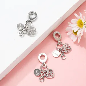 Zilveren familie- en oneindigheidsbedeltjes op witte treden met roze achtergrond voor sieraden